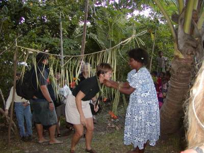 Kathy is greeted by a local villager at the special dinner